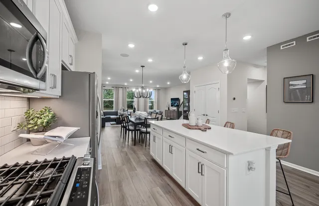 a kitchen with a sink stove and cabinets
