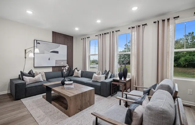 a living room with furniture and a large window