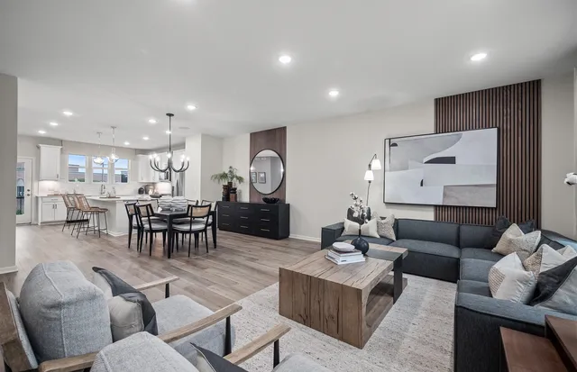 a living room with furniture and kitchen view