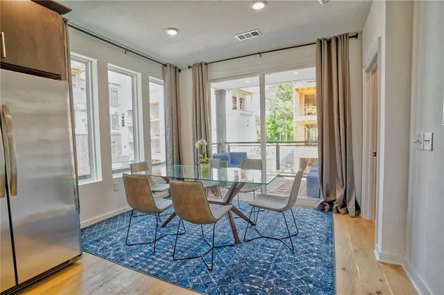 a outdoor living space with patio furniture and a rug