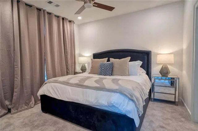 a bedroom with a large bed and a large window