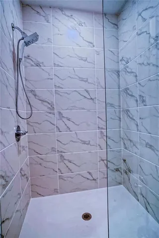 a bathroom with a toilet and a shower