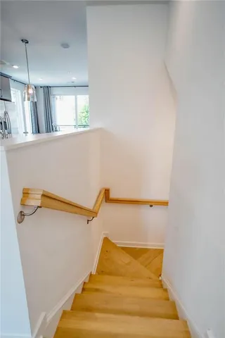 a view of a hallway with a bathroom and a sink