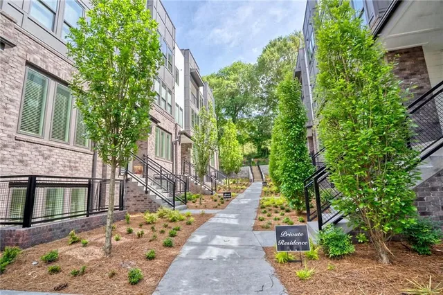 a view of a livingroom with wooden floor and a flat screen tv