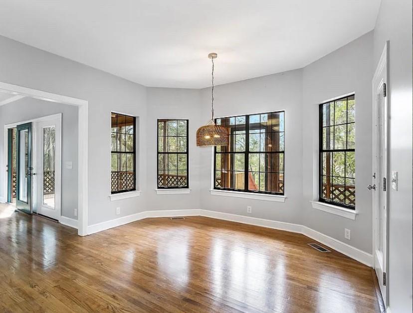 1525 Black Island Road Darien, GA 31305 - Photo 5 of 41 a view of an empty room with wooden floor and a window