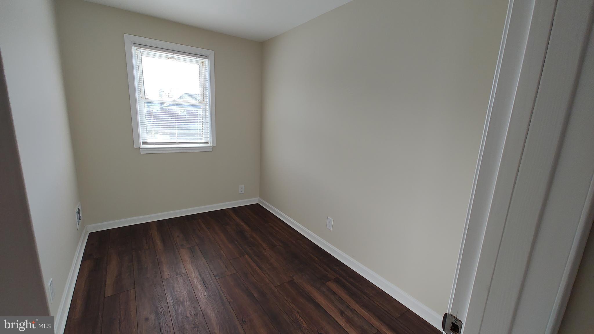 2247 Graythorn Road Middle River, MD 21220 - Photo 21 of 29 a view of an empty room with wooden floor and a window
