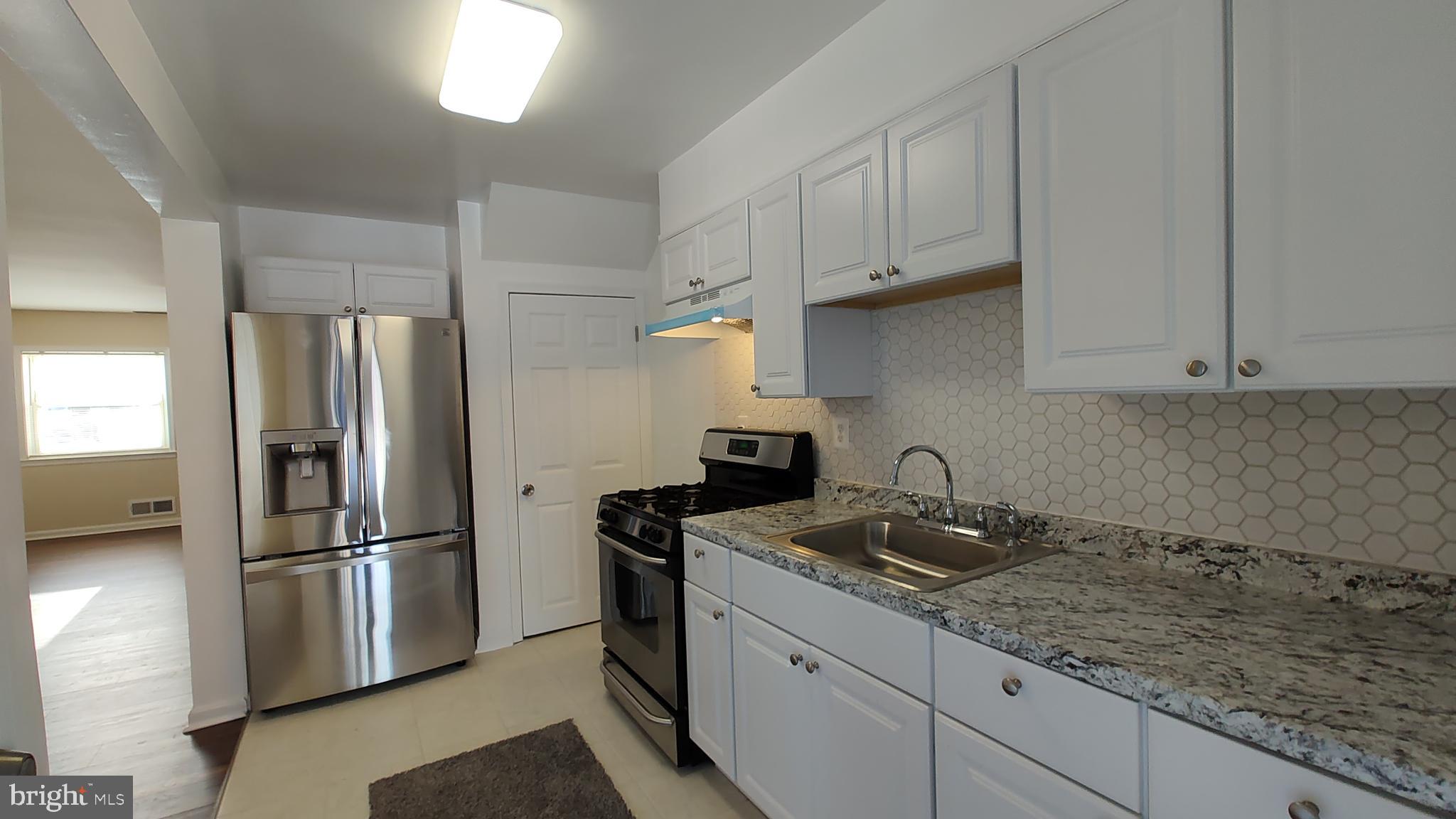 2247 Graythorn Road Middle River, MD 21220 - Photo 10 of 29 a kitchen with stainless steel appliances granite countertop a refrigerator sink and stove