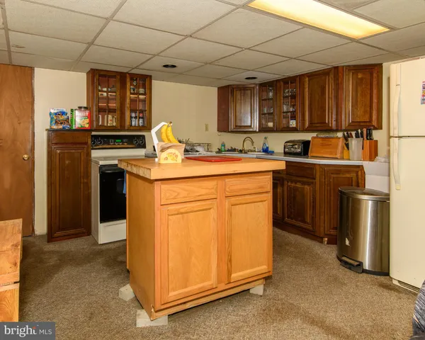 a kitchen with stainless steel appliances granite countertop a stove a sink dishwasher and a refrigerator