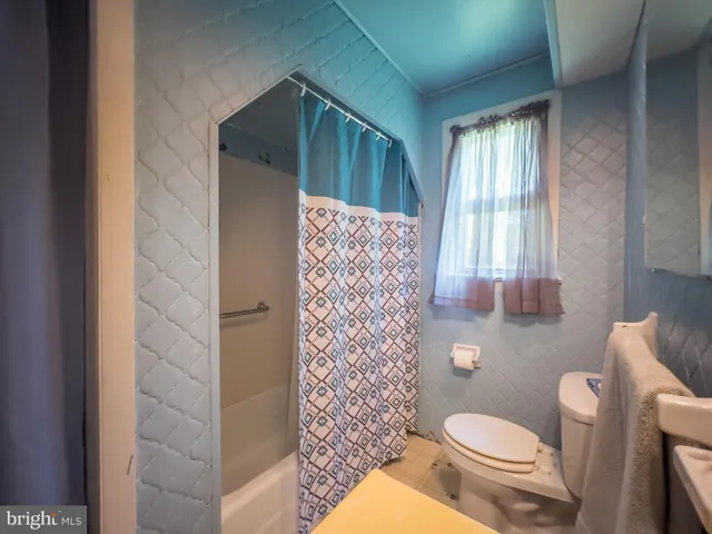 a bathroom with a toilet a sink and a shower