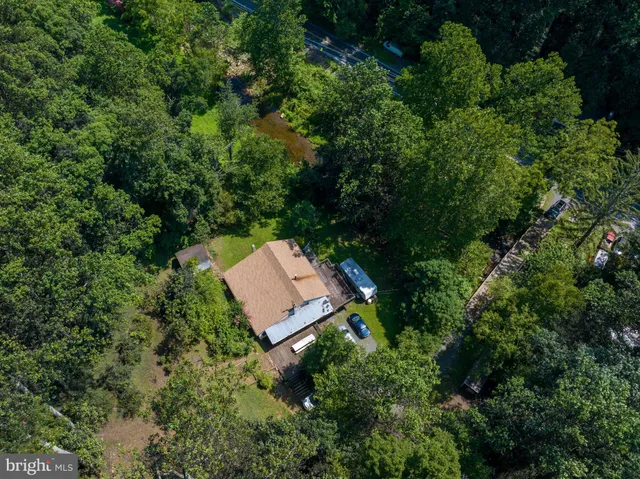 an aerial view of a house with a yard