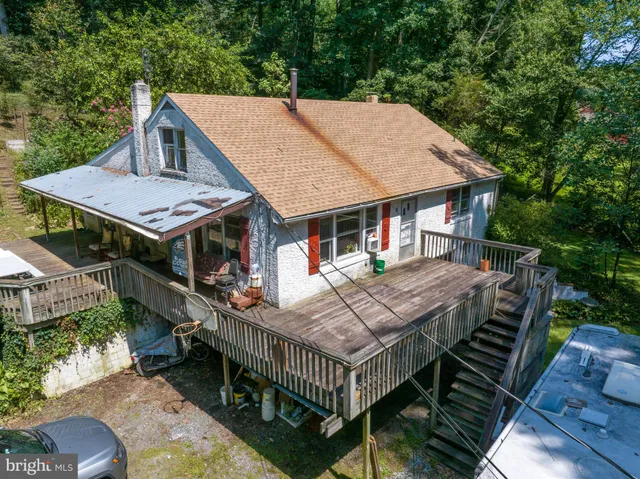 an aerial view of a house with roof deck front of house