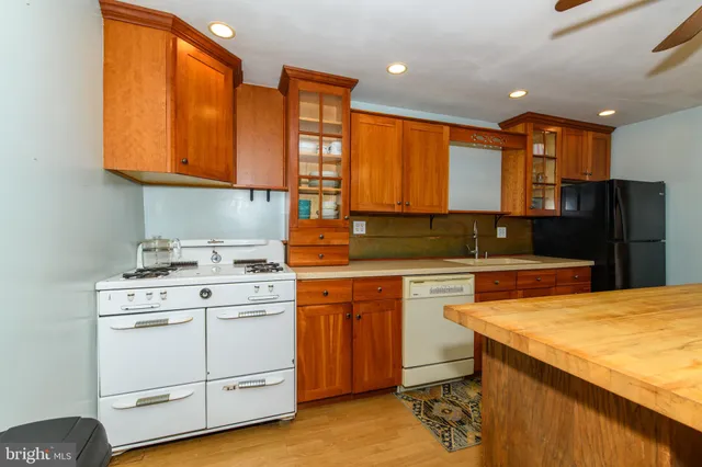 a kitchen with a stove a sink and a refrigerator