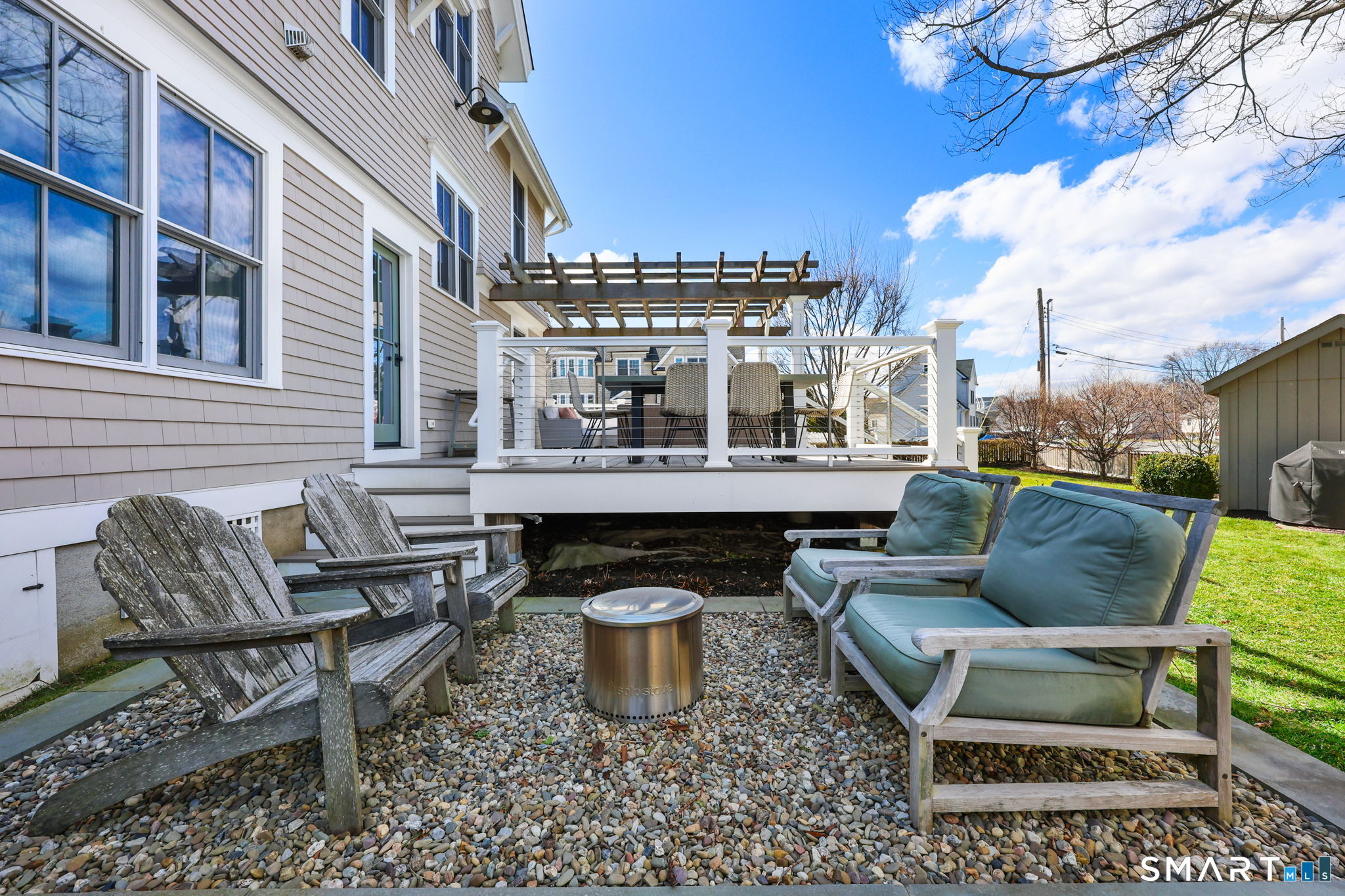 693 South Benson Road Fairfield, CT 06824 - Photo 31 of 40 Step down for a little shade and a fire