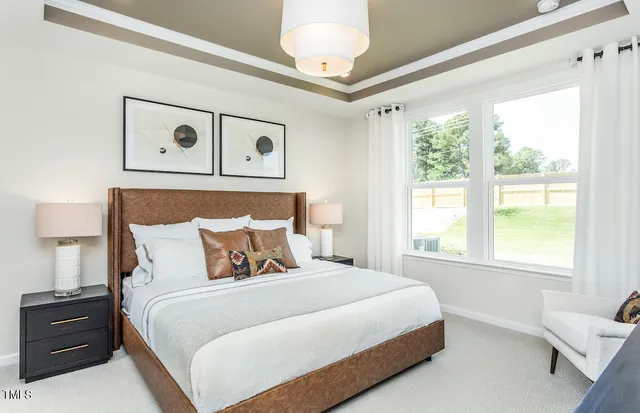 a living room with furniture a flat screen tv and a large window