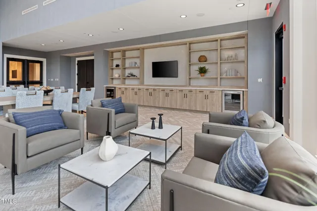 a living room with furniture a table and a large window