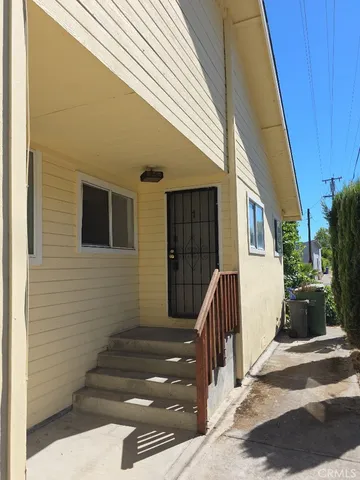 a view of house with wooden fence and large windows