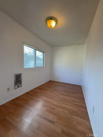 an empty room with windows and mirror