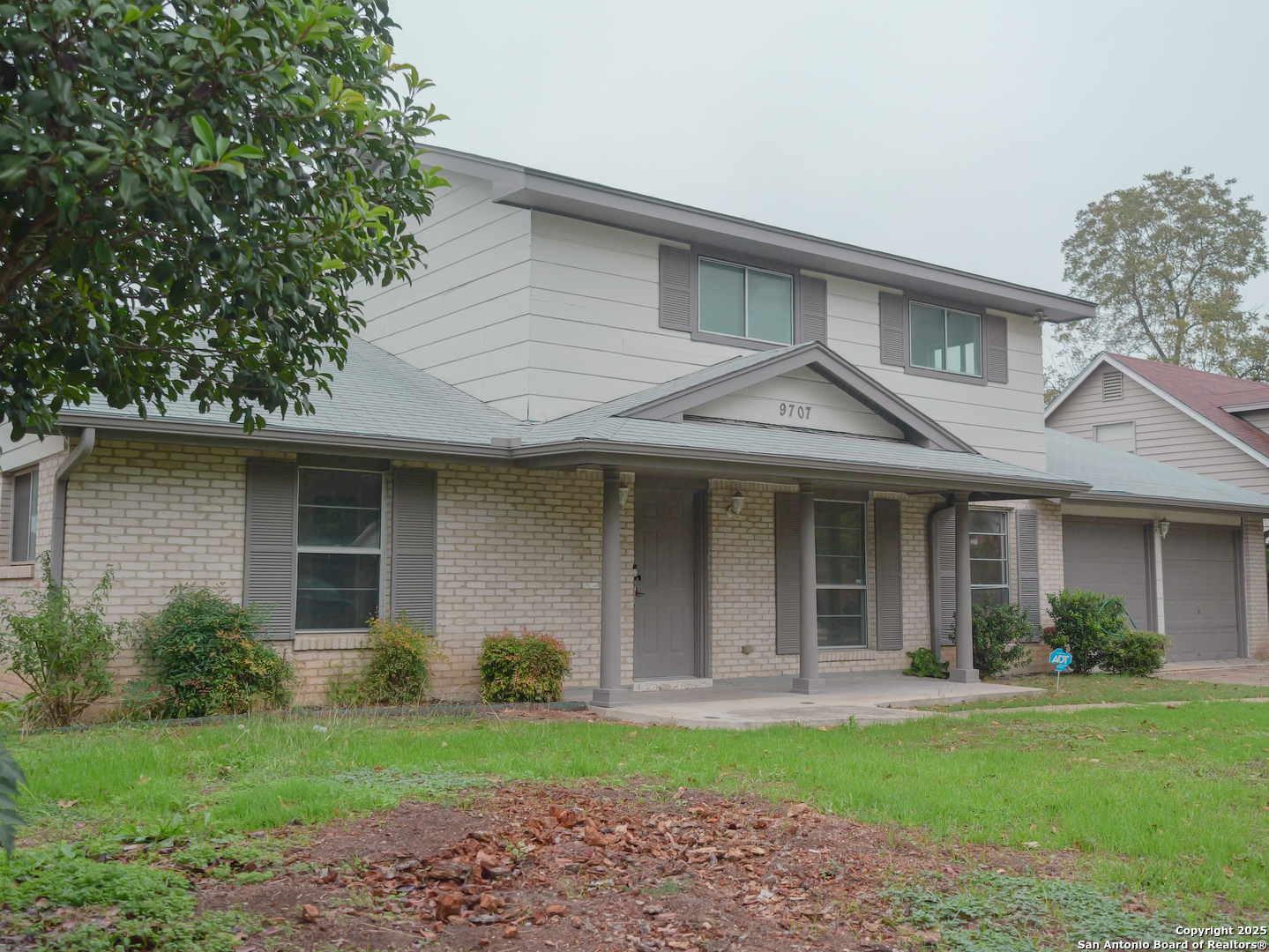 a front view of a house with a garden