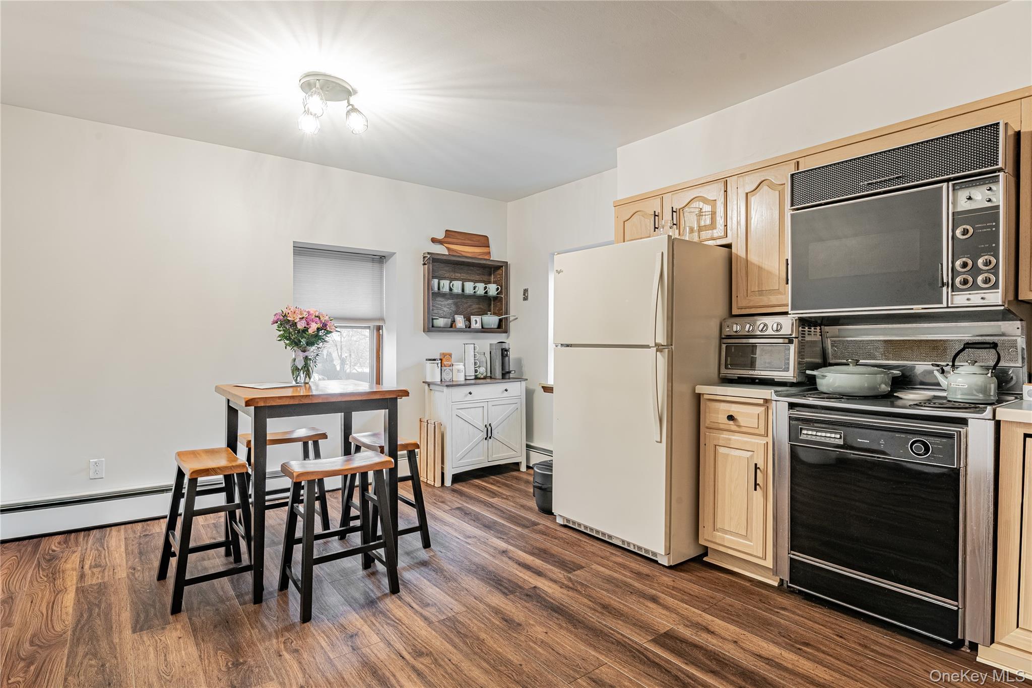23 Musselman Drive Poughkeepsie, NY 12601 - Photo 18 of 34 Kitchen with black appliances, light countertops, dark wood-type flooring, and light brown cabinetry