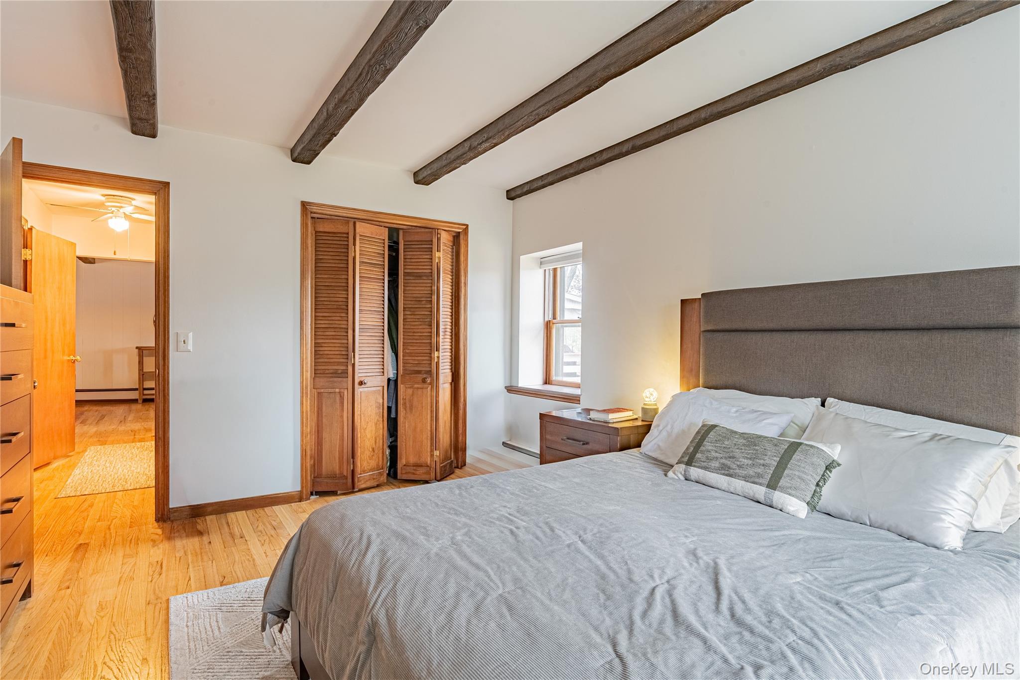 23 Musselman Drive Poughkeepsie, NY 12601 - Photo 24 of 34 Bedroom with beam ceiling, light wood finished floors, a closet, and a baseboard heating unit