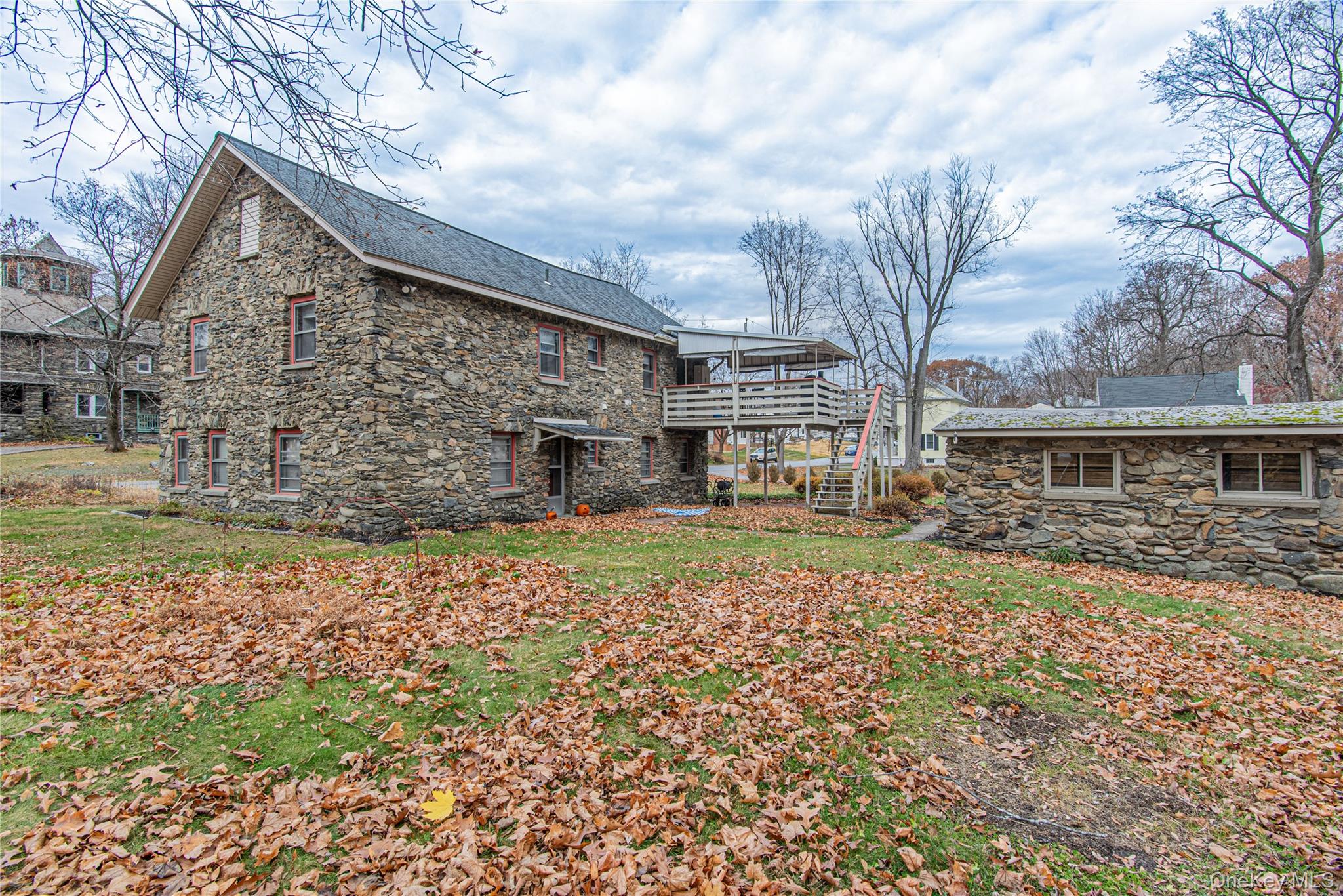 23 Musselman Drive Poughkeepsie, NY 12601 - Photo 32 of 34 Rear view of house with stone siding, a wooden deck, and a chimney