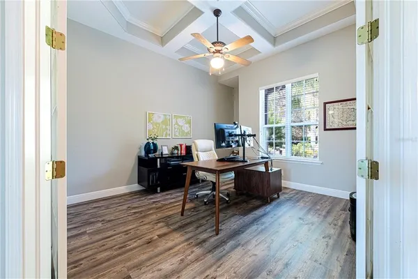 a living room with furniture a flat screen tv and a large window
