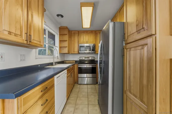 a kitchen with stainless steel appliances granite countertop a refrigerator and a sink