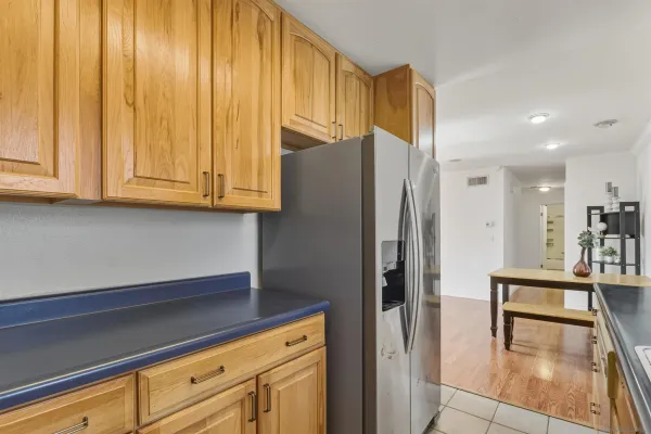 a kitchen with stainless steel appliances granite countertop a refrigerator and a stove top oven