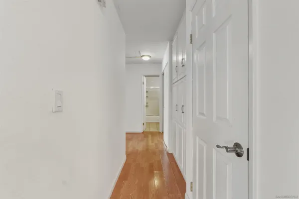 a view of a hallway with wooden floor