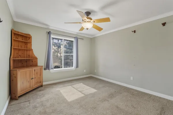 a very nice looking room with a ceiling fan and window