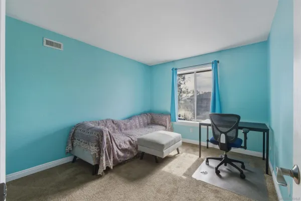 a bedroom with a bed a table and a window