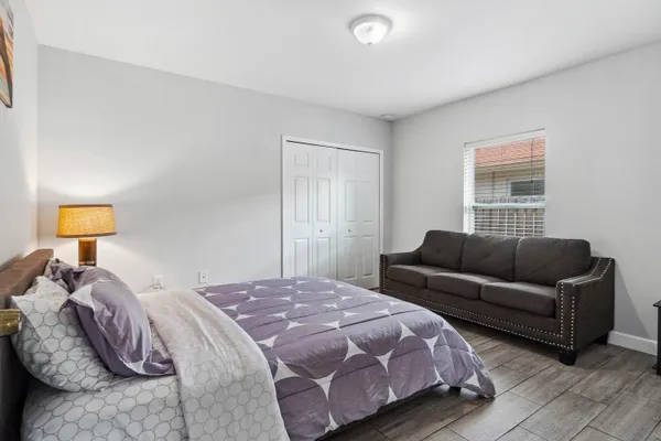 a bedroom with a bed and couch