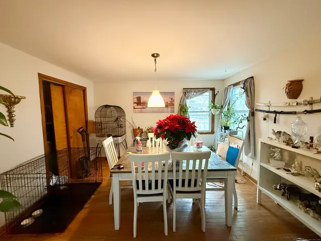 a view of a dining room with furniture and chandelier