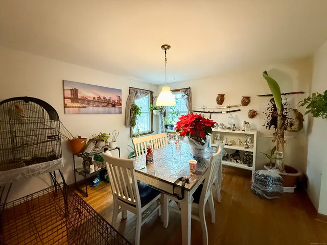 a kitchen with stainless steel appliances granite countertop a refrigerator a stove a sink dishwasher and white cabinets with wooden floor