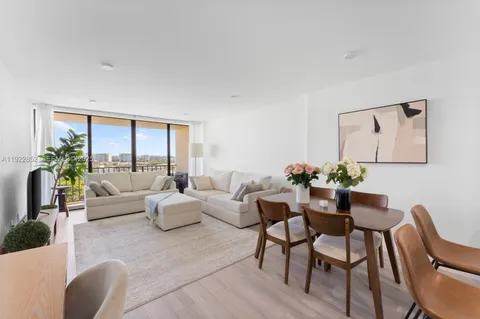 a living room with furniture potted plant a window and a potted plant