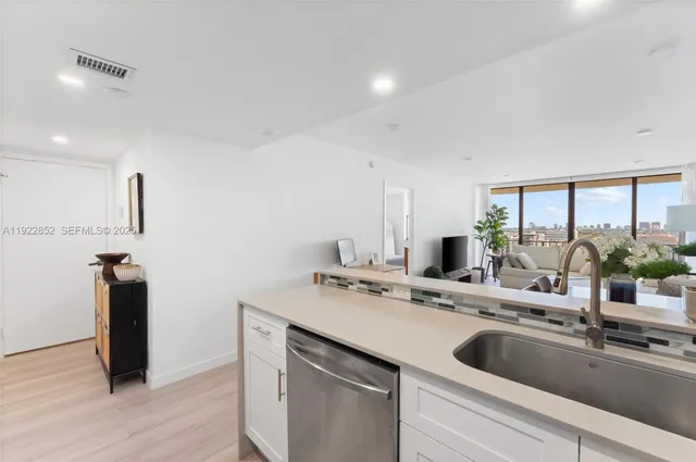 a kitchen with a sink and a refrigerator