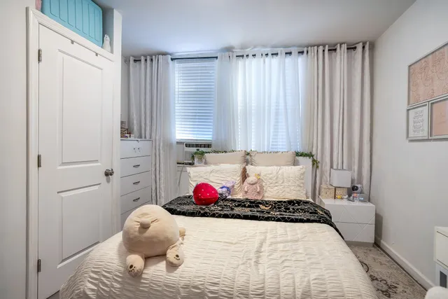 a bed room with a bed and a window