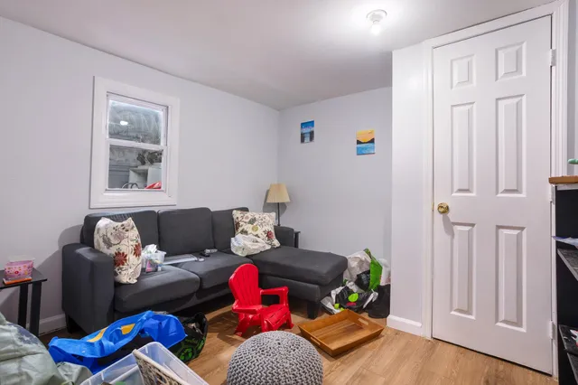 a living room with furniture chess board and wooden floor