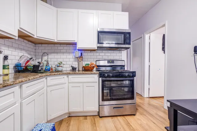 a kitchen with stainless steel appliances a stove and a refrigerator