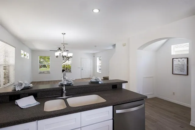a kitchen with a sink and chandelier