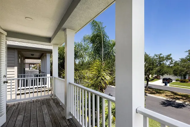 an empty room with windows and ceiling fan