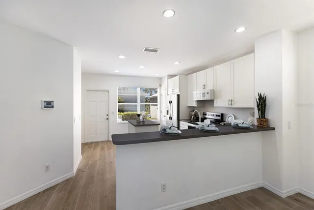 a kitchen with sink refrigerator and window