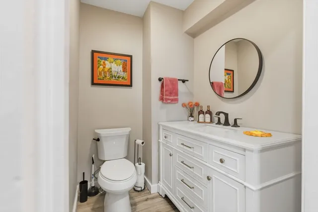 a bathroom with a toilet a sink and a mirror