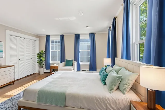 a bedroom with a large bed and a window