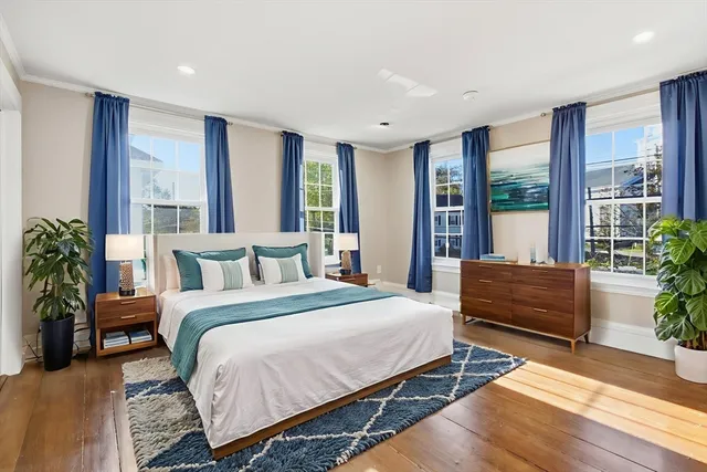 a spacious bedroom with a large bed and a large window