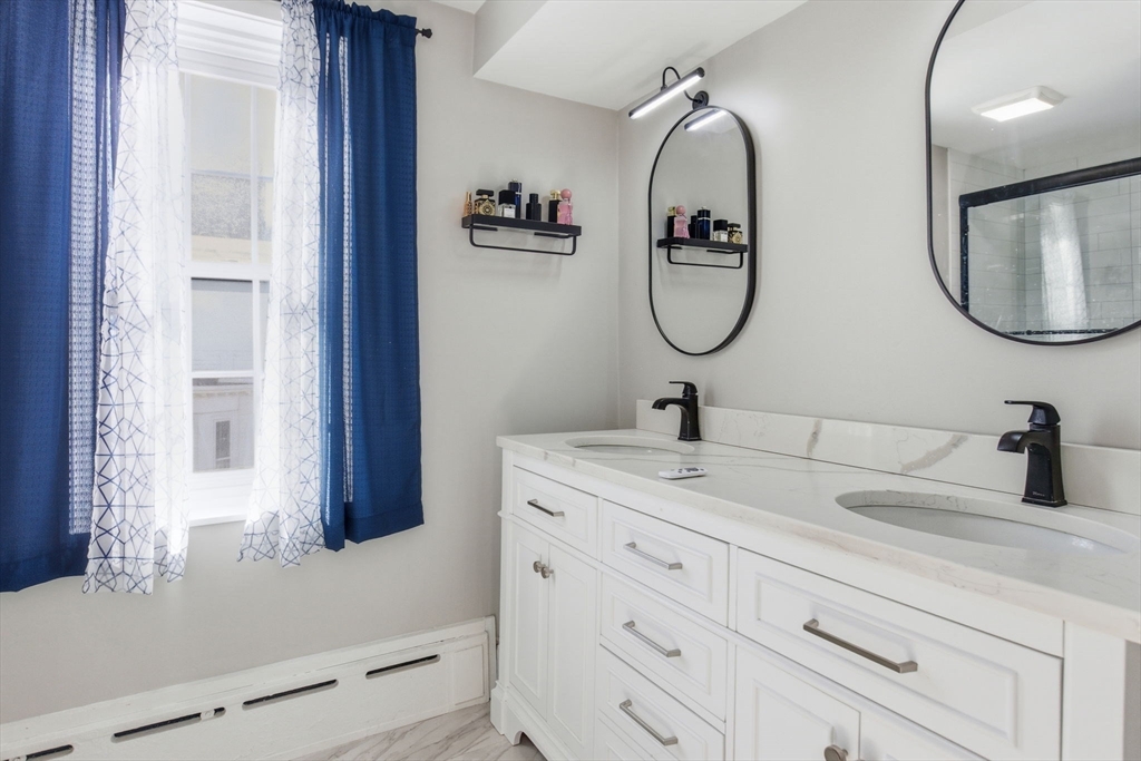 12 Salem Street, Unit 2 Haverhill, MA 01835 - Photo 19 of 34 a bathroom with a double vanity sink and a mirror