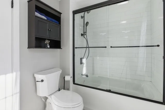 a bathroom with a toilet and a shower