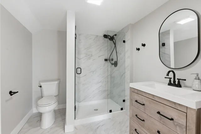 a bathroom with a sink a toilet and a mirror