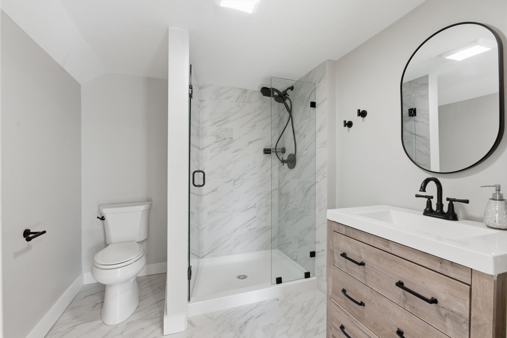 12 Salem Street, Unit 2 Haverhill, MA 01835 - Photo 28 of 34 a bathroom with a sink a toilet and a mirror