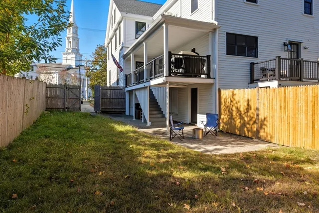 a view of a house with backyard and sitting area
